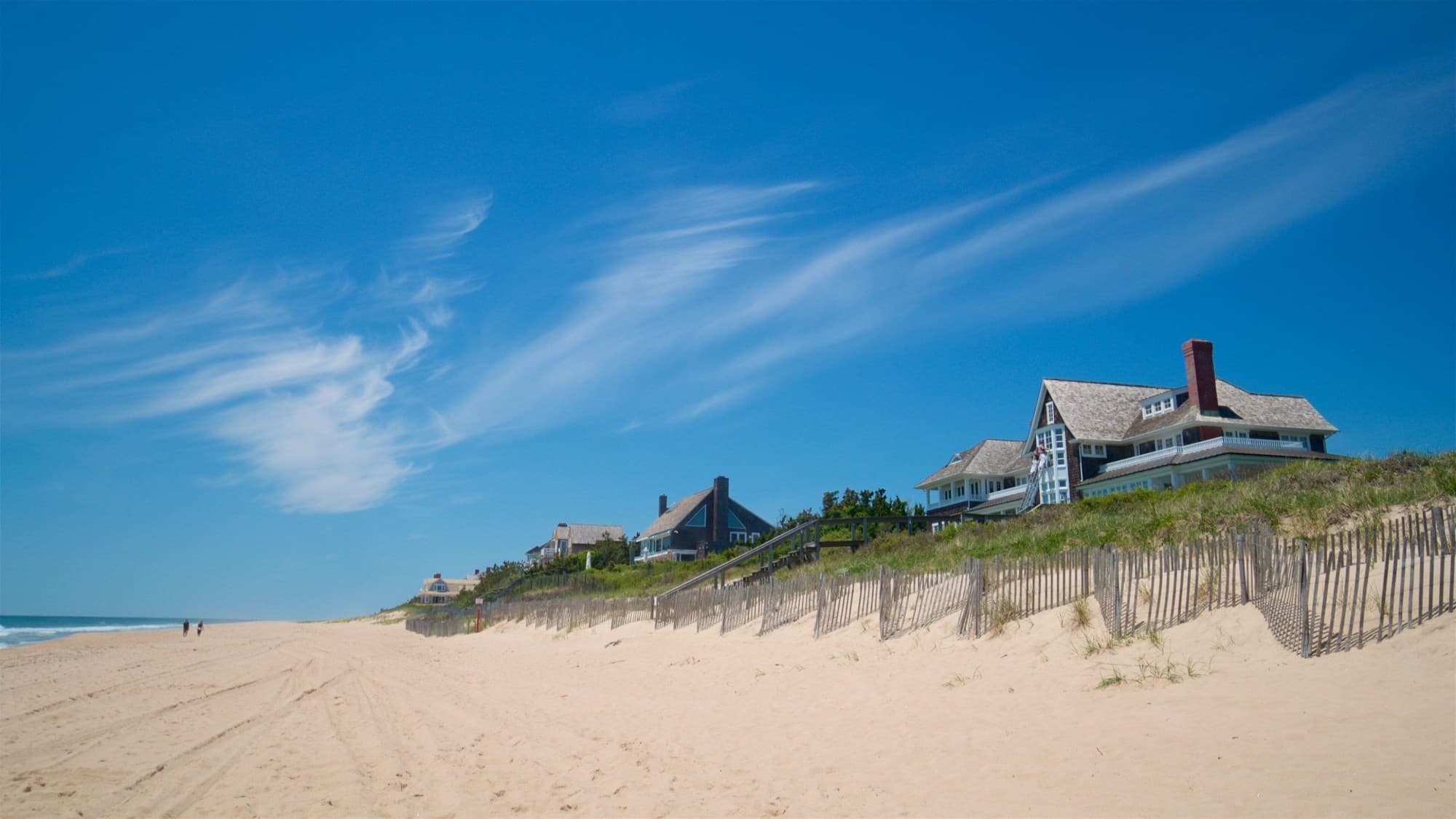 Shingle houses above the dunes and snow fences on the beach at East Hampton