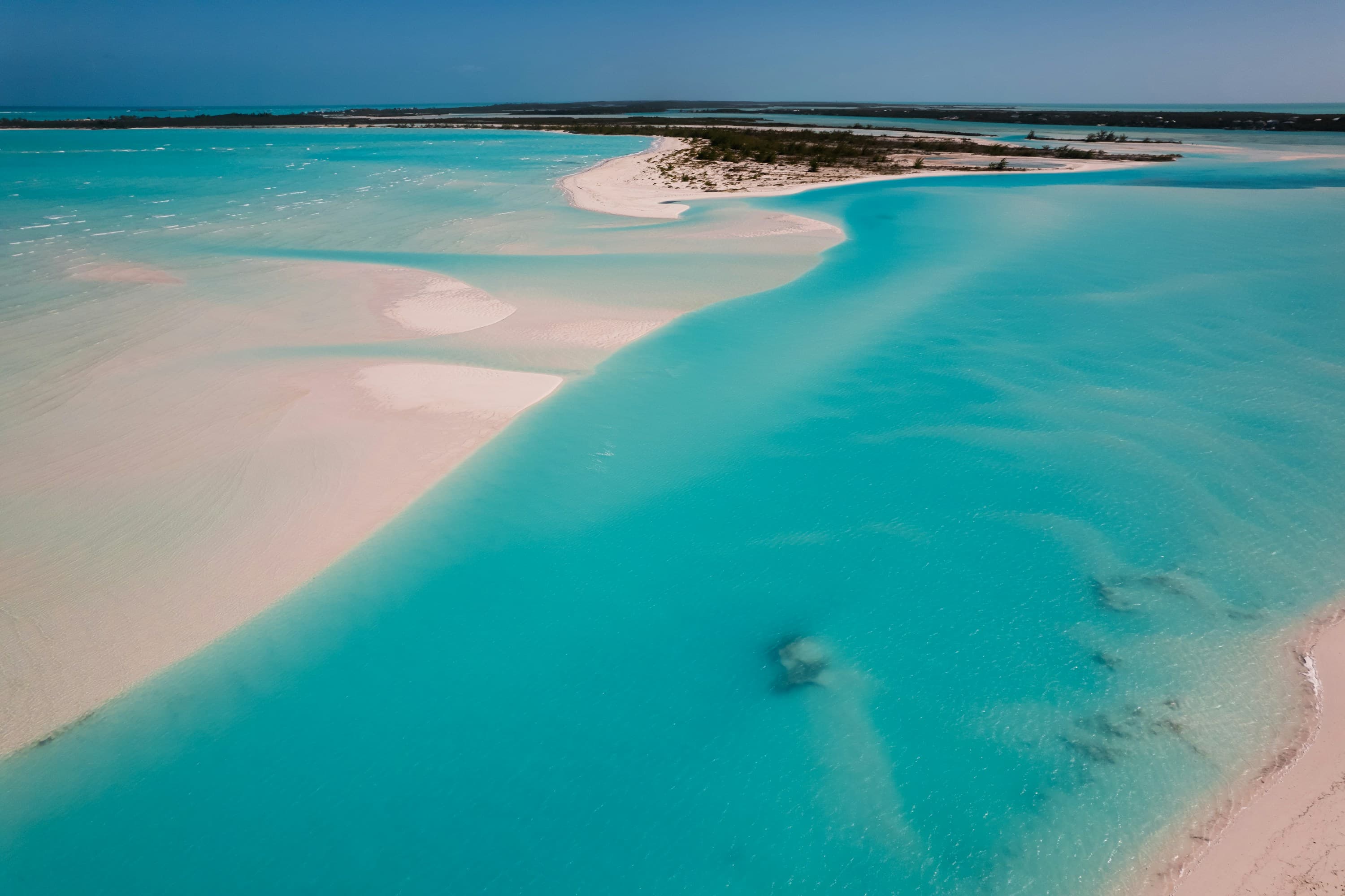 A sandbar and turquoise shallows in the Bahamas from above